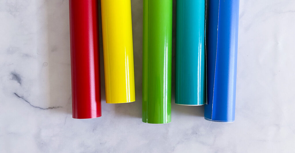 rolls of vinyl in red, yellow, green, teal, and blue