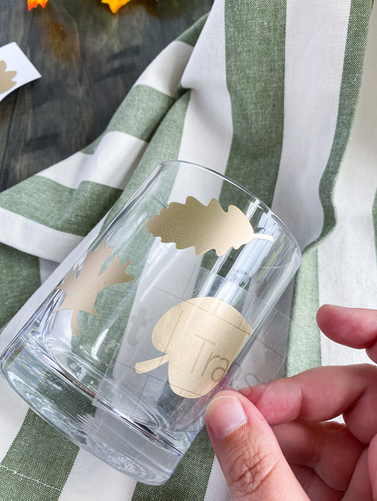 using transfer tape to apply gold vinyl leaves to glass