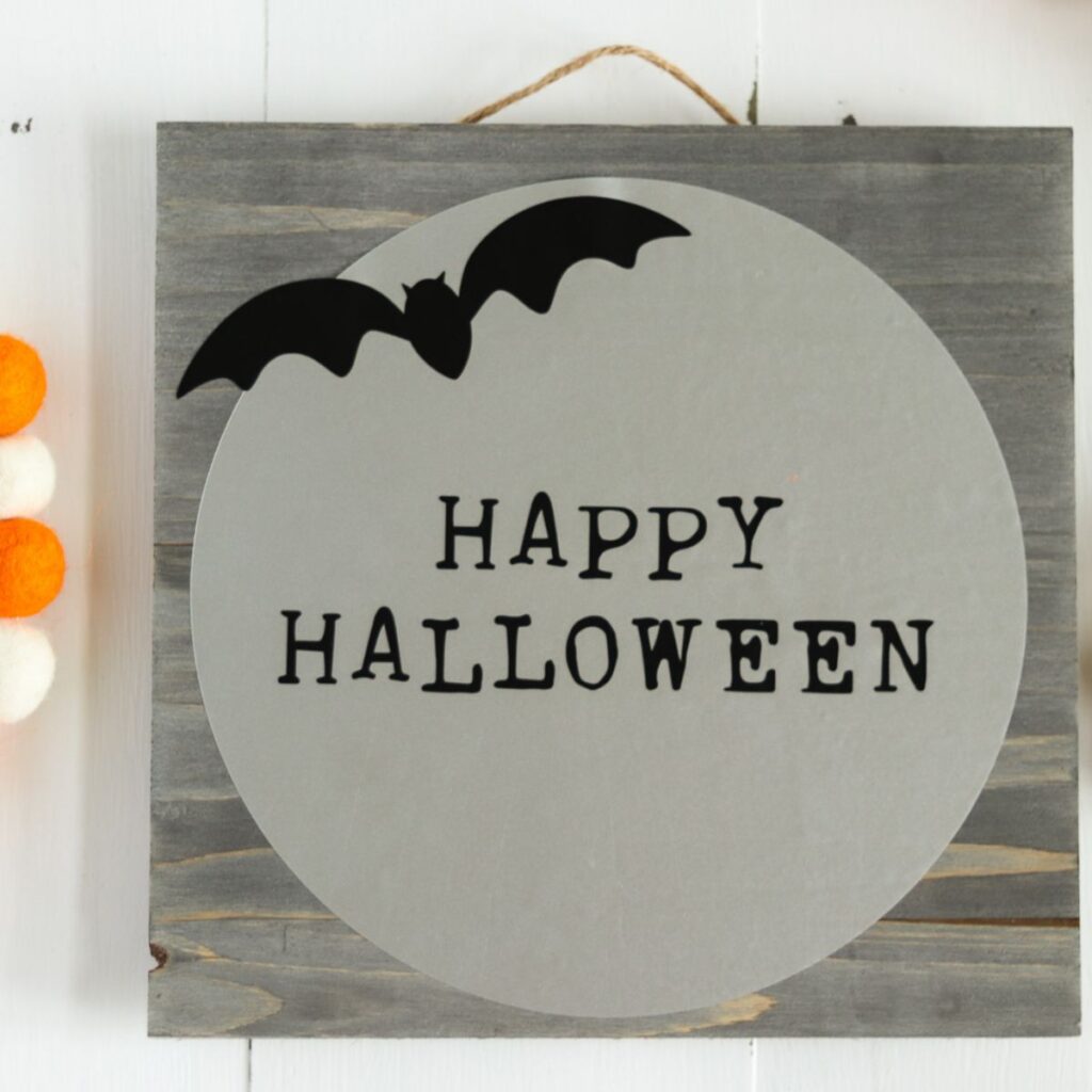 Happy Halloween sign with bat on moon