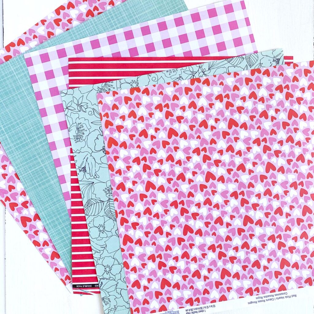 patterned scrapbook paper in pink, red, and aqua