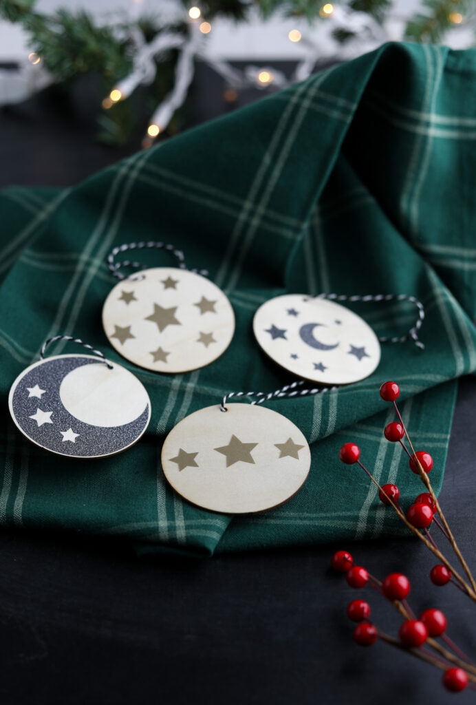 moon and star ornaments on green plaid linen