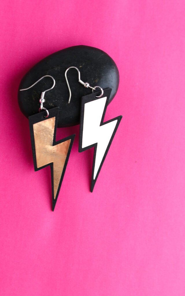 faux leather lightning earrings on rock